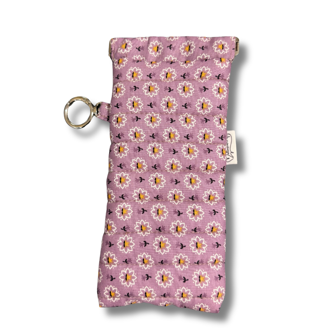 Floral patterned pouch with a key ring on a white background