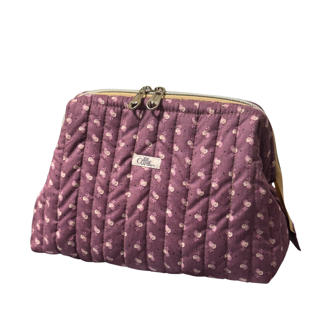 Purple quilted handbag with a visible brand label on a white background