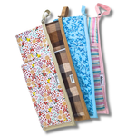 Four fabric bags with different patterns and colors on a white background