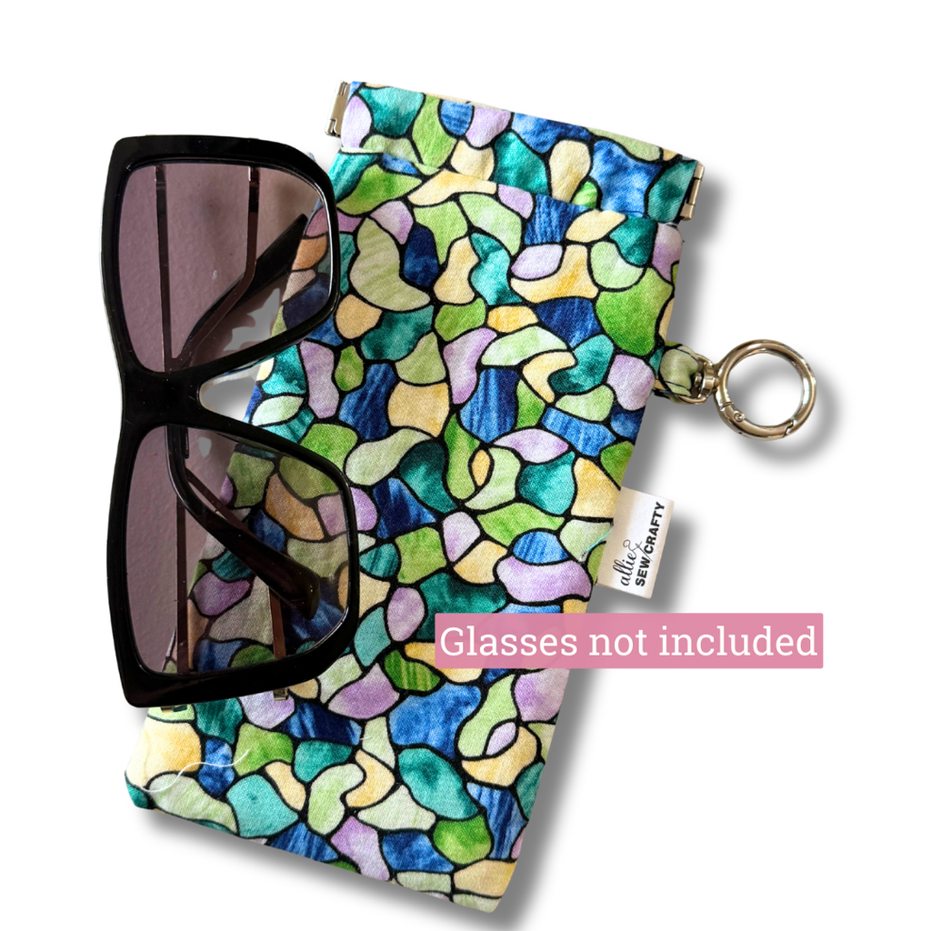 Sunglasses with a colorful patterned case on a white background