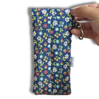 Blue Wildflowers Meadow quilted Flexi Frame Pouch, closed, showing the Allie Sew Crafty label and swivel clip