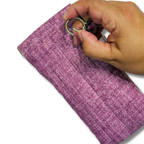 Hand pushing a round swivel hook open against the plum pouch on a white background
