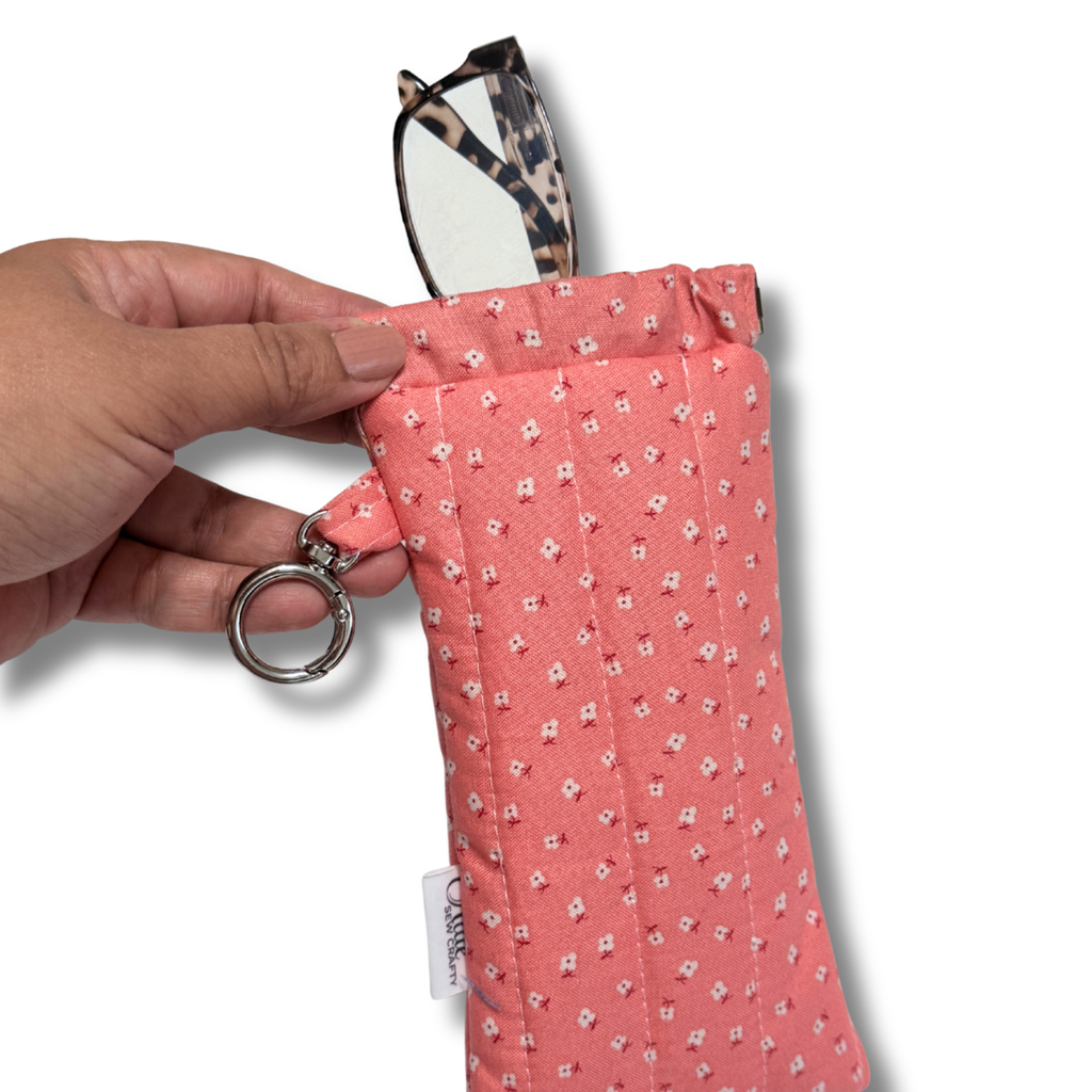 Pink Dainty Daisies quilted Flexi Frame Pouch holding a pair of glasses