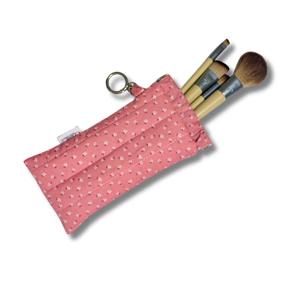 Pink Dainty Daisies quilted Flexi Frame Pouch filled with makeup brushes