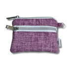 A small purple woven fabric zippered pouch with two silver metal zippers and a small white brand tag on the side, shown on a white background.