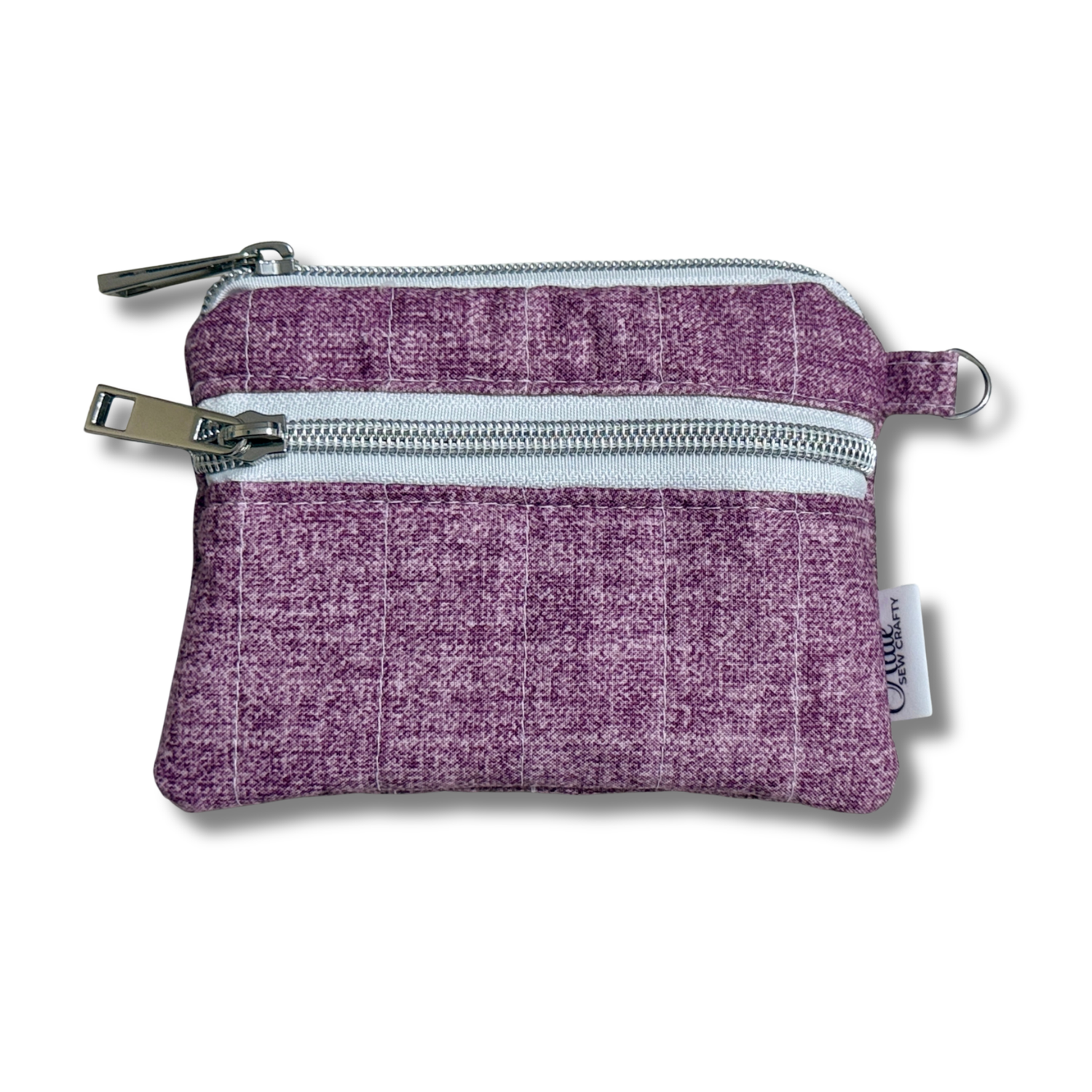 A small purple woven fabric zippered pouch with two silver metal zippers and a small white brand tag on the side, shown on a white background.