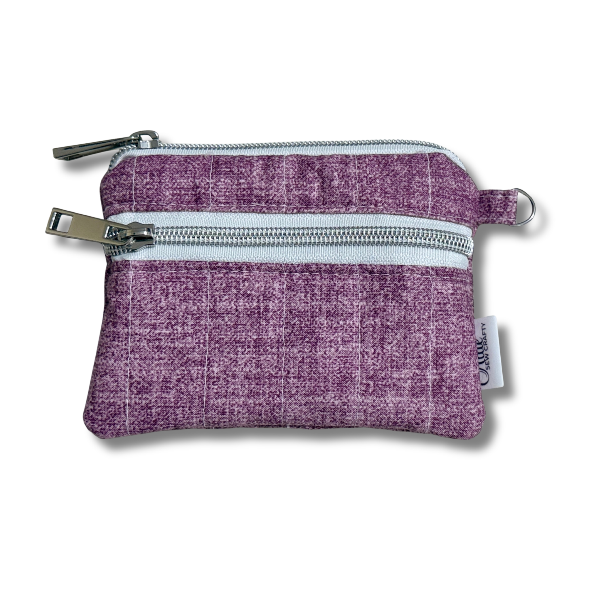 A small purple woven fabric zippered pouch with two silver metal zippers and a small white brand tag on the side, shown on a white background.