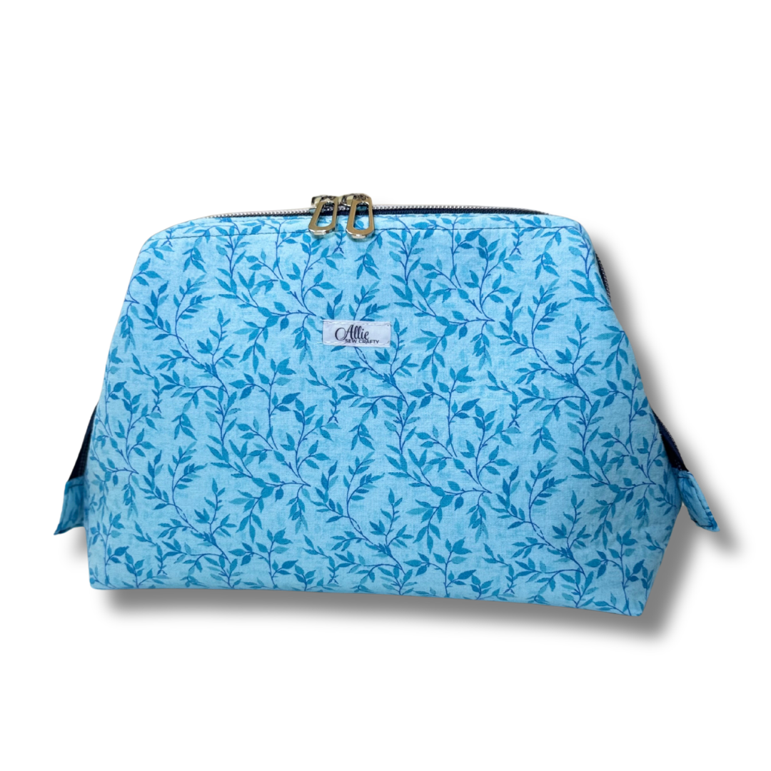 Blue floral-patterned bag with a visible brand logo on a white background