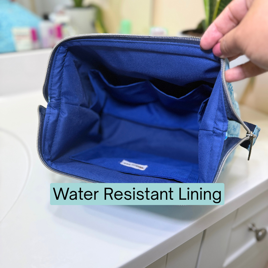 Blue toiletry bag with water-resistant lining on a counter