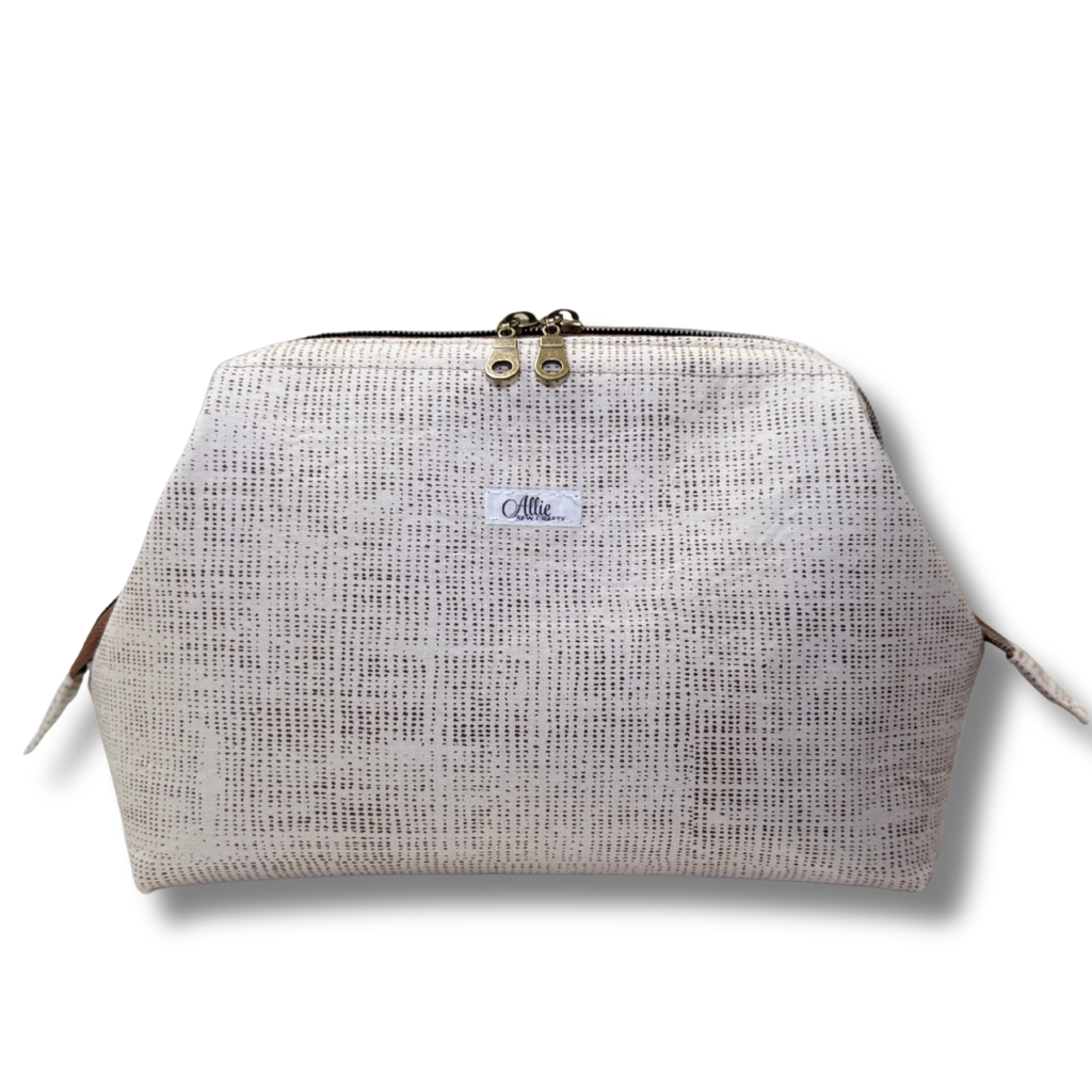 Textured beige pouch with a brand label on a white background