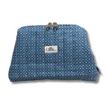 A zippered pouch with a blue and teal geometric pattern, featuring a white  plain white background with a white label that reads "Allie Sew Crafty"