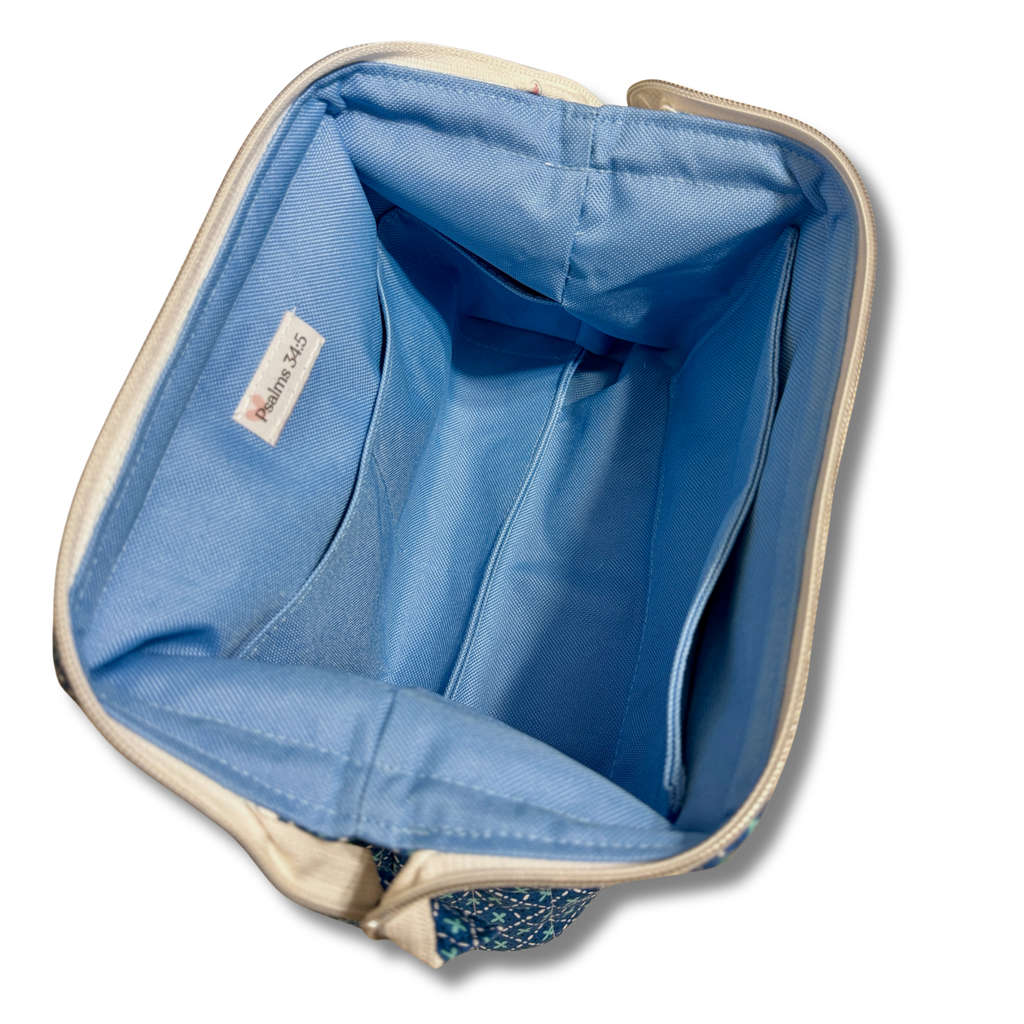 Open pouch with blue periwinkle lining and label that says Psalms 34:5 in a plain white background