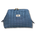 A blue and white patterned cosmetic pouch with a gold-tone metal clasp and a white brand label reading 'Allie The Beauty Box'.
