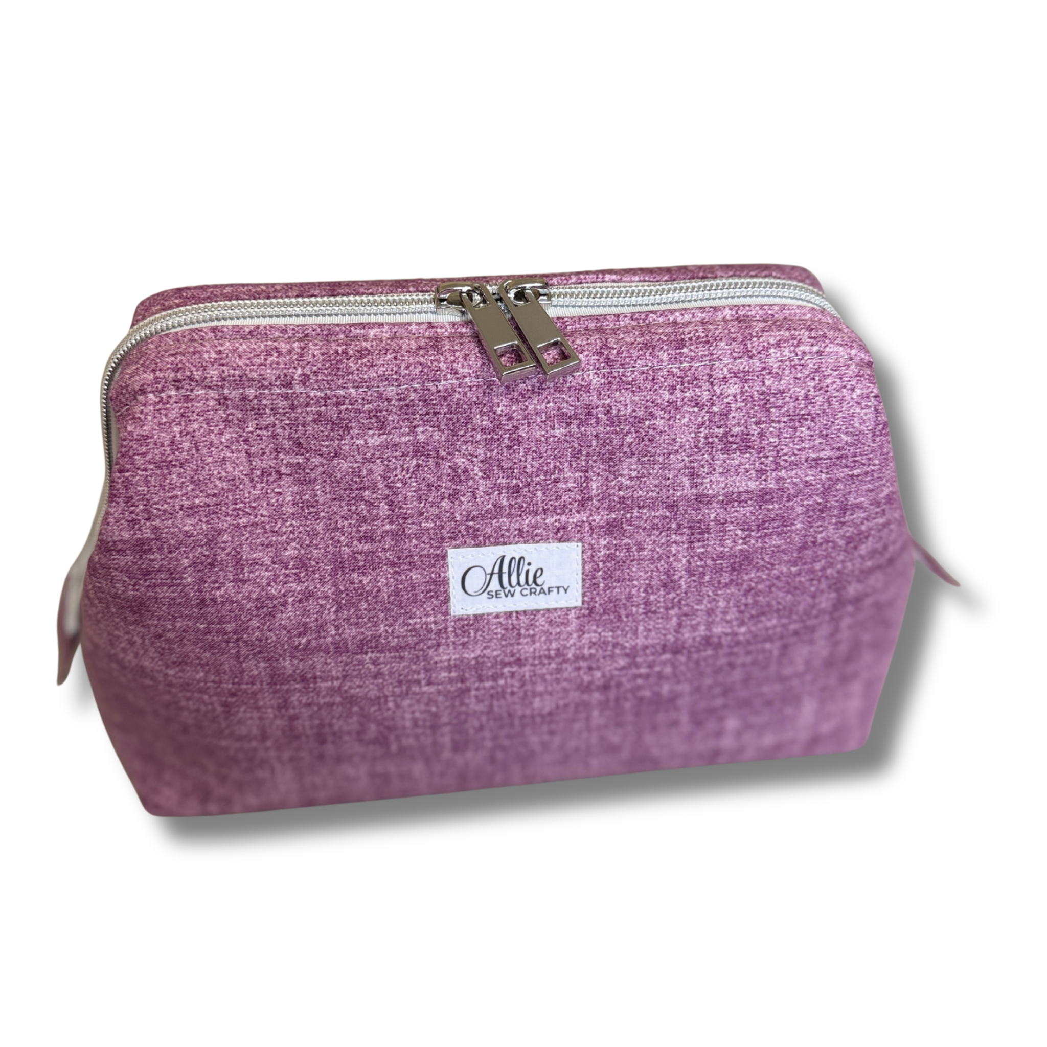 Closed Solid Heathered Plum smooth quilted Full View Pouch, angled view, sitting on a countertop