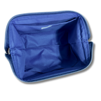 The interior of a blue zippered cosmetic bag or organizer pouch, showing fabric compartments and a zipper, isolated on a white background.