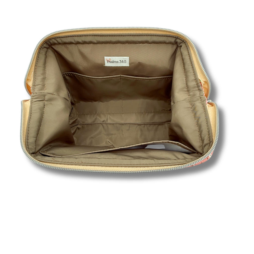 An open beige zippered pouch showing its interior lining, which is a warm tan color with a small white label reading 'Psalms 34:5'.