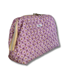 A quilted lavender closed cosmetic pouch with a daisy floral pattern, featuring a cream zipper and a small white label 'Allie Sew Crafty' brand label.