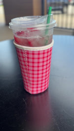 video of pink gingham cup sleeve on black table