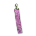 A purple glittery fabric wristlet strap with a gold-tone lobster clasp, shown on a plain white background.